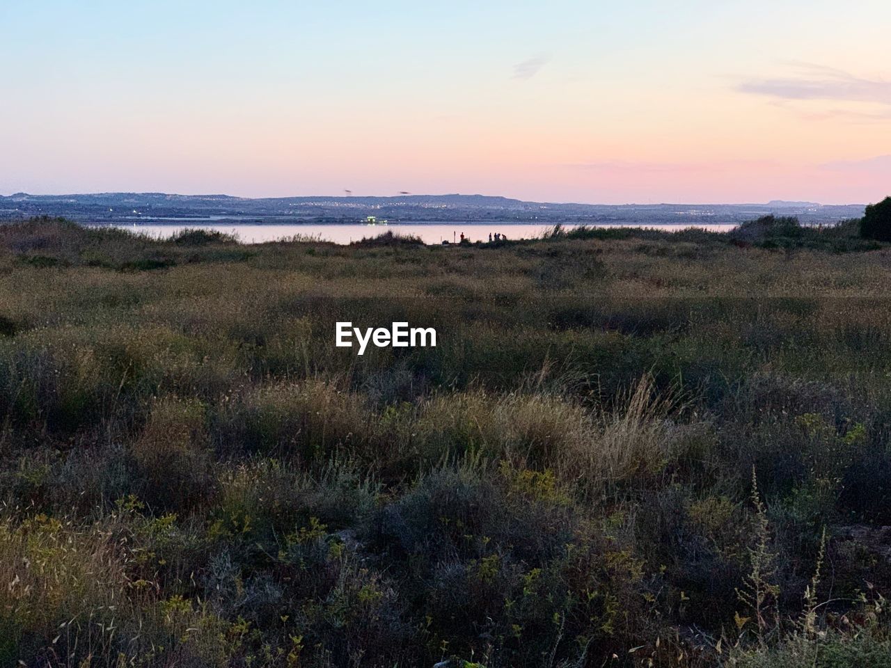 Scenic view of land against sky during sunset