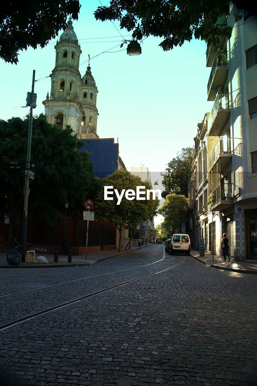 VIEW OF CITY STREET WITH CHURCH