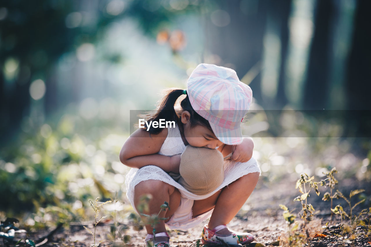 Girl crouching on field