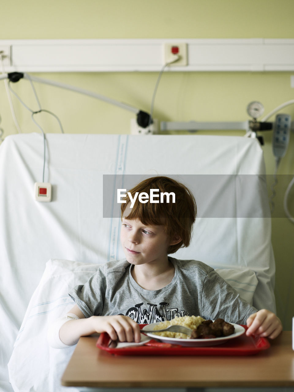 Boy eating meal in hospital