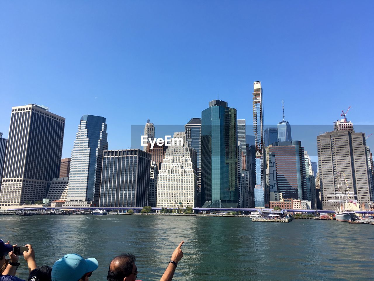 Modern buildings in city against clear blue sky