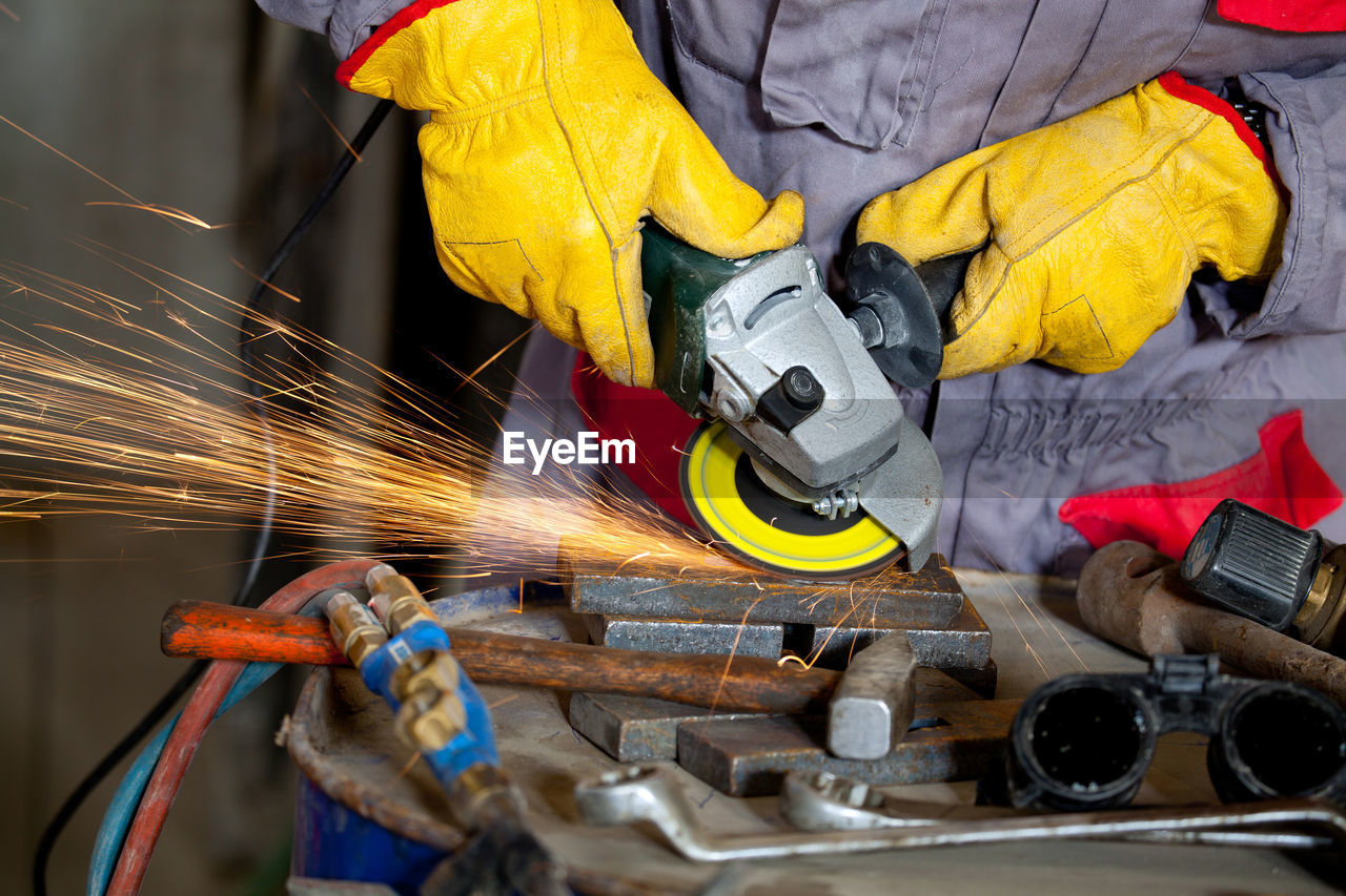 Midsection of worker working in workshop