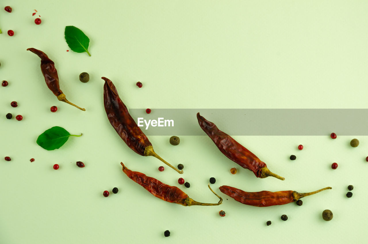 Background of dried pepper, leaves and peppercorns