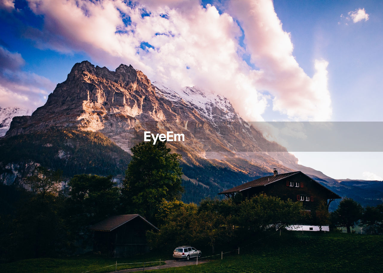 SCENIC VIEW OF MOUNTAINS AND BUILDING AGAINST SKY