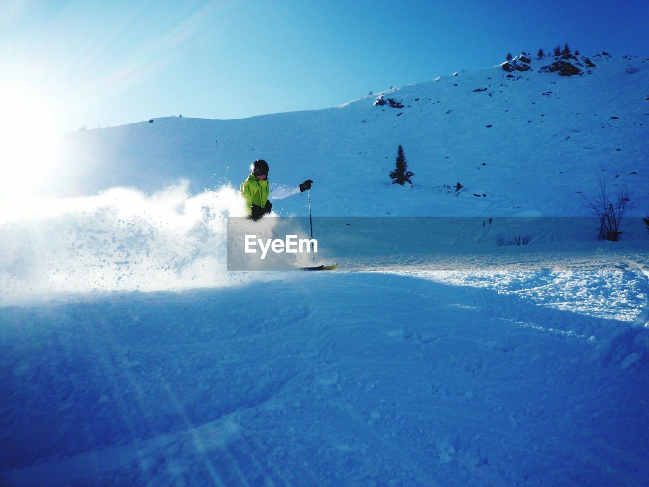 Man skiing on mountain against sky