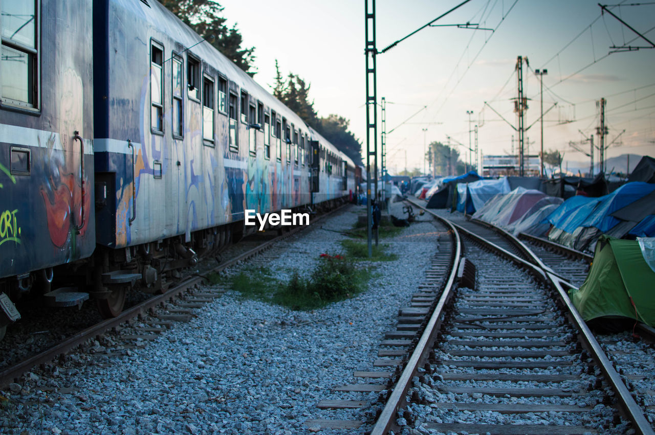 RAILROAD TRACKS AGAINST SUNSET