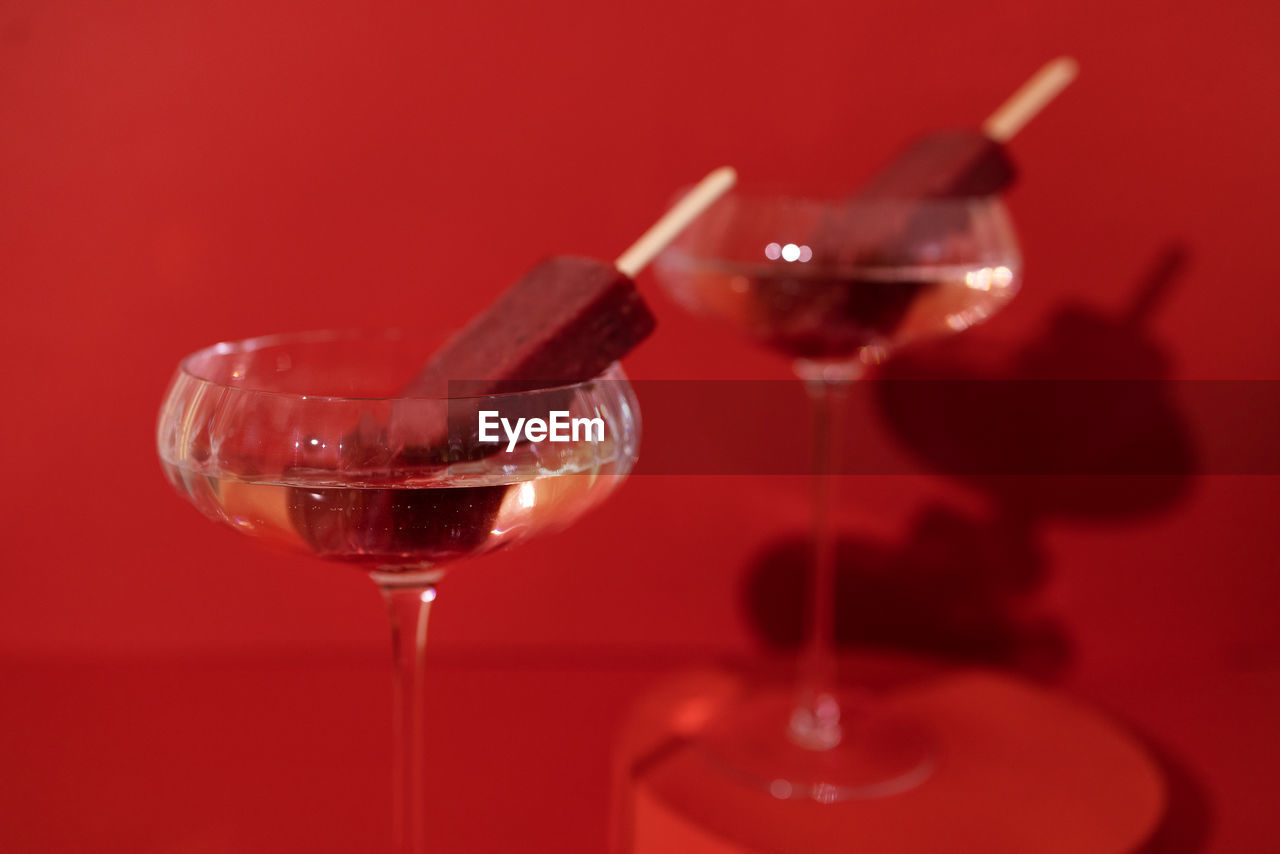 close-up of champagne flute against yellow background