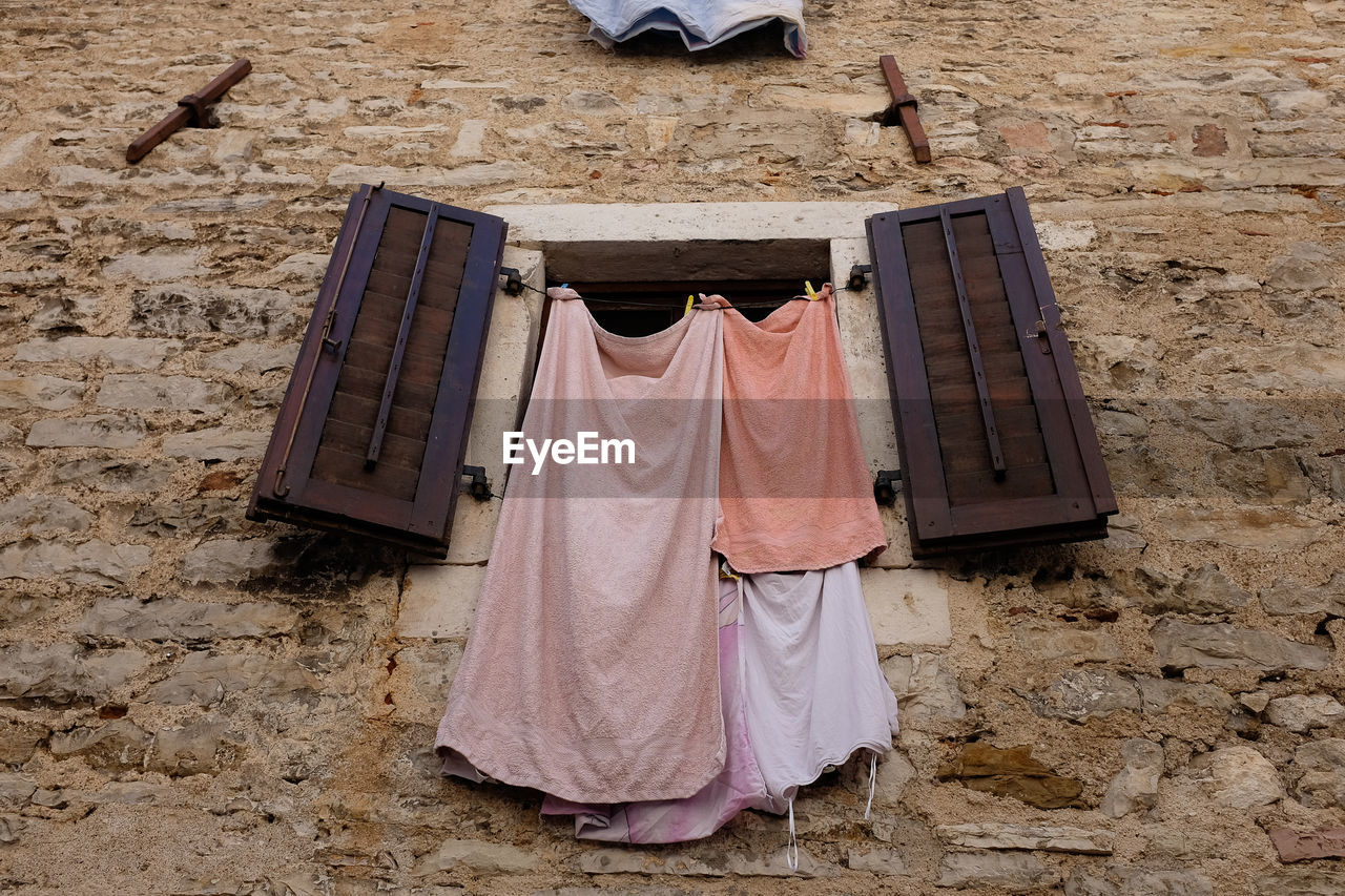 Drying laundry out of a window on clothes line