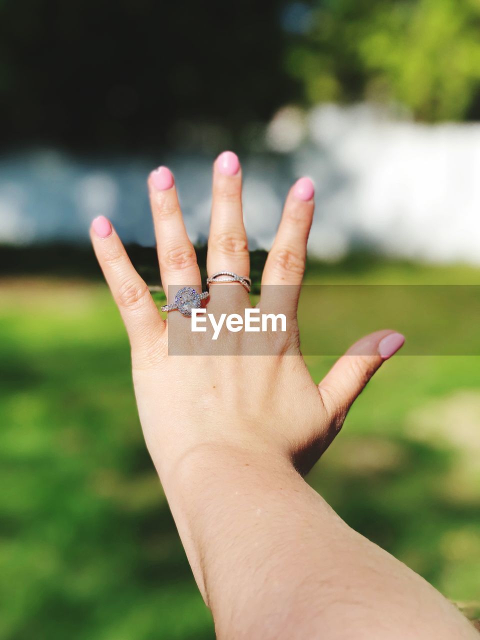 Close-up cropped woman wearing rings during sunny day