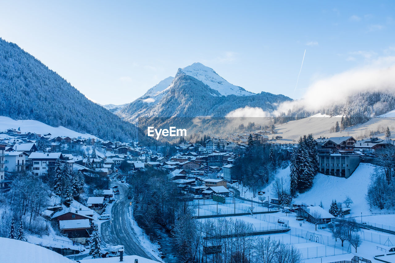 Scenic view of snowcapped mountains and houses