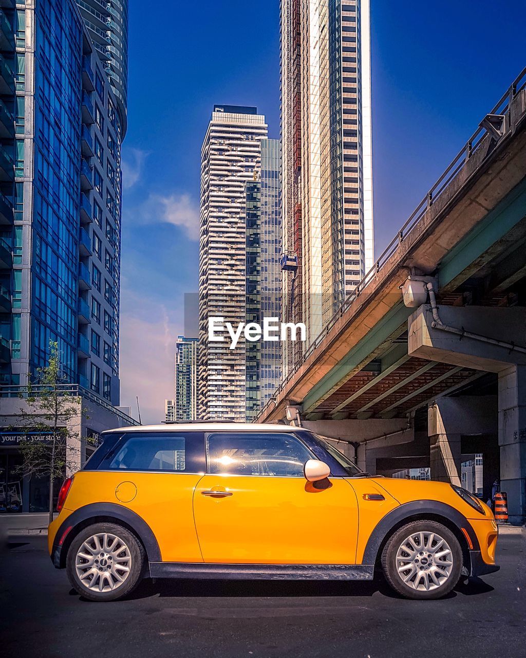 CAR ON ROAD AGAINST BUILDINGS