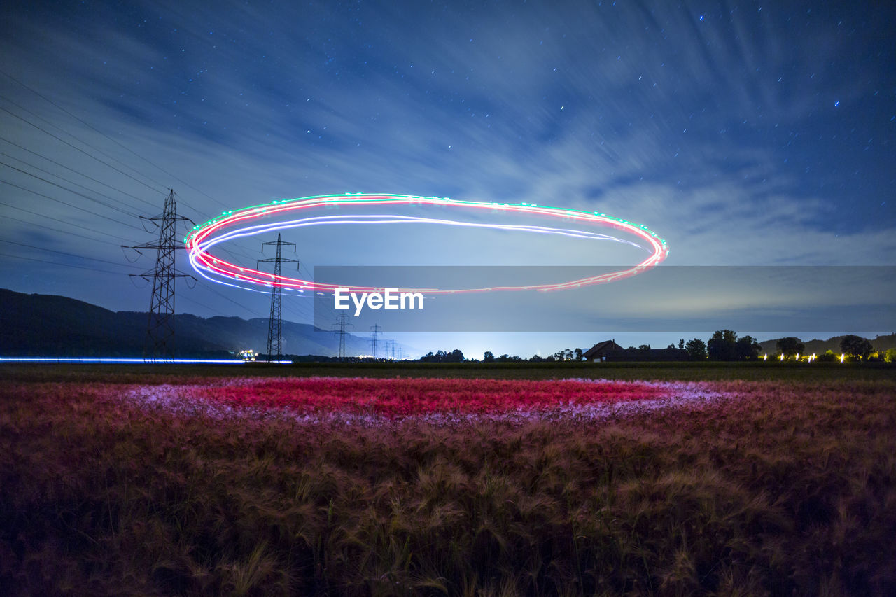 Light trails in mid-air against blue sky