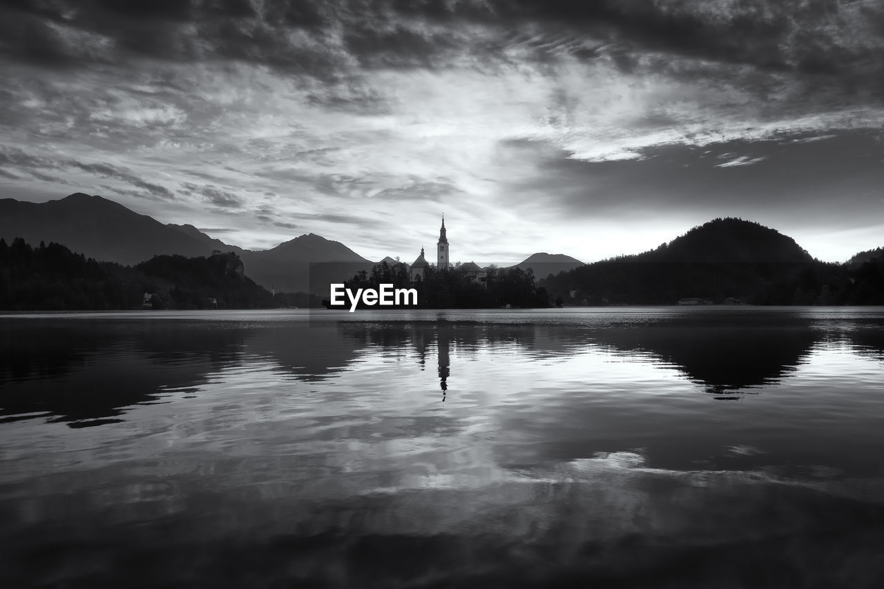 Scenic view of lake against cloudy sky