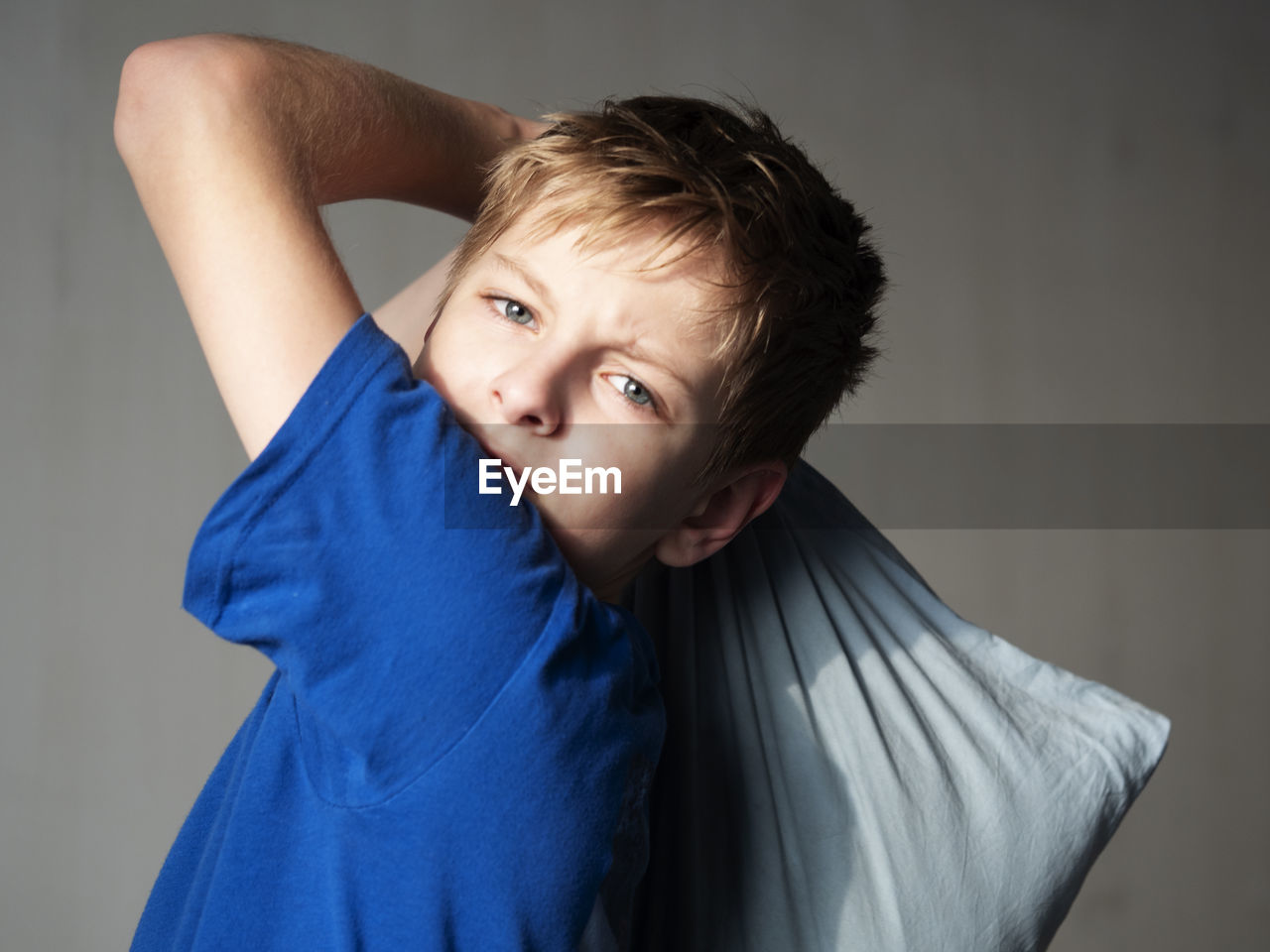 PORTRAIT OF BOY STANDING IN FRONT OF TWO PEOPLE