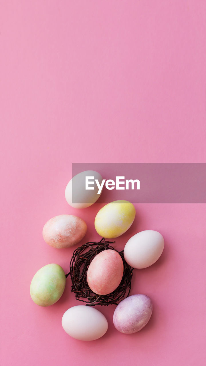 Easter eggs in pastel color on a light pink background, light easter,  vertical format for stories