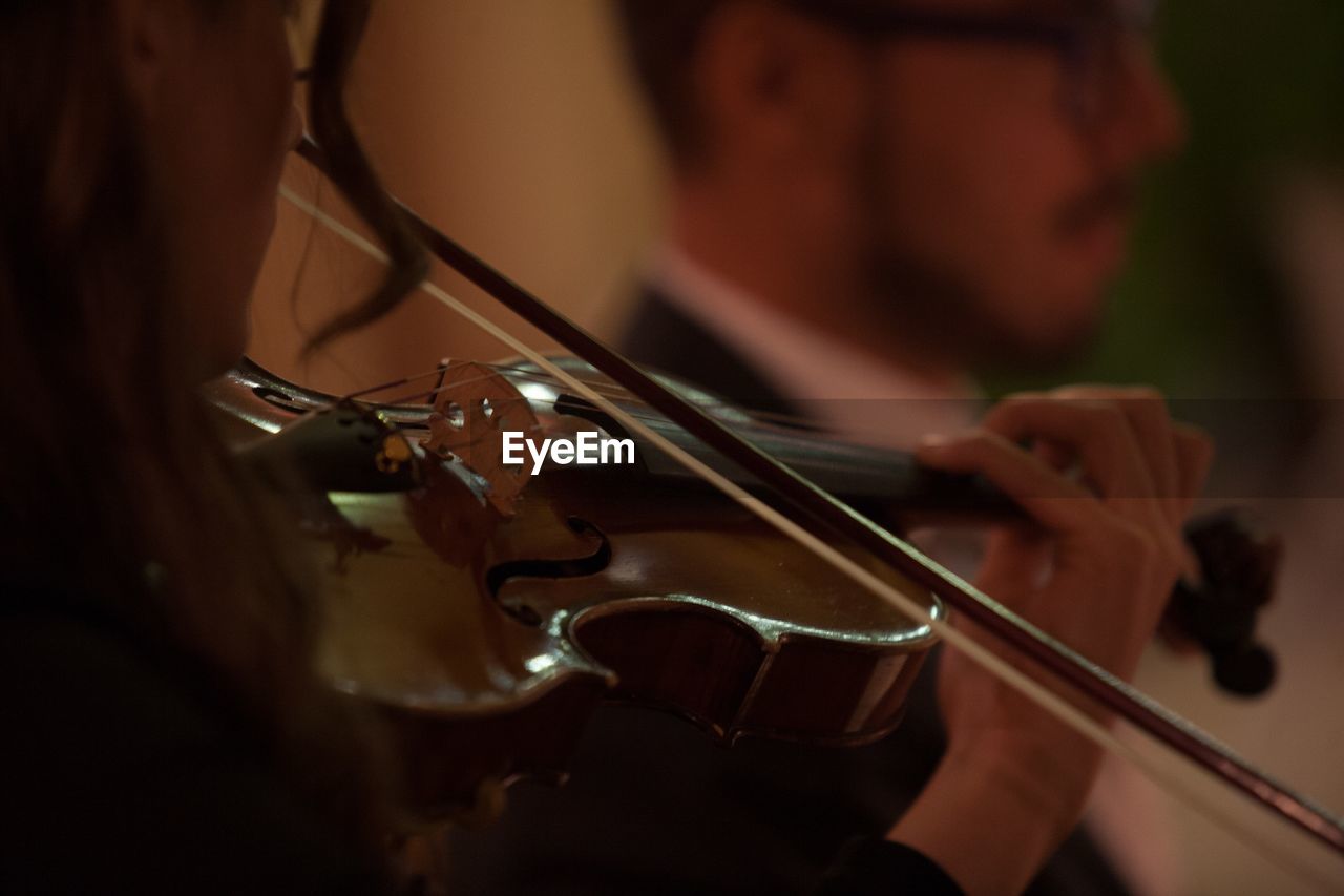 Close-up of man playing violin