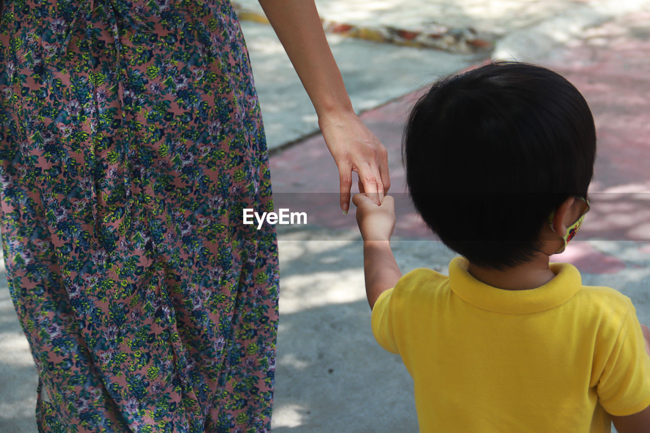 Mother and child shake hands