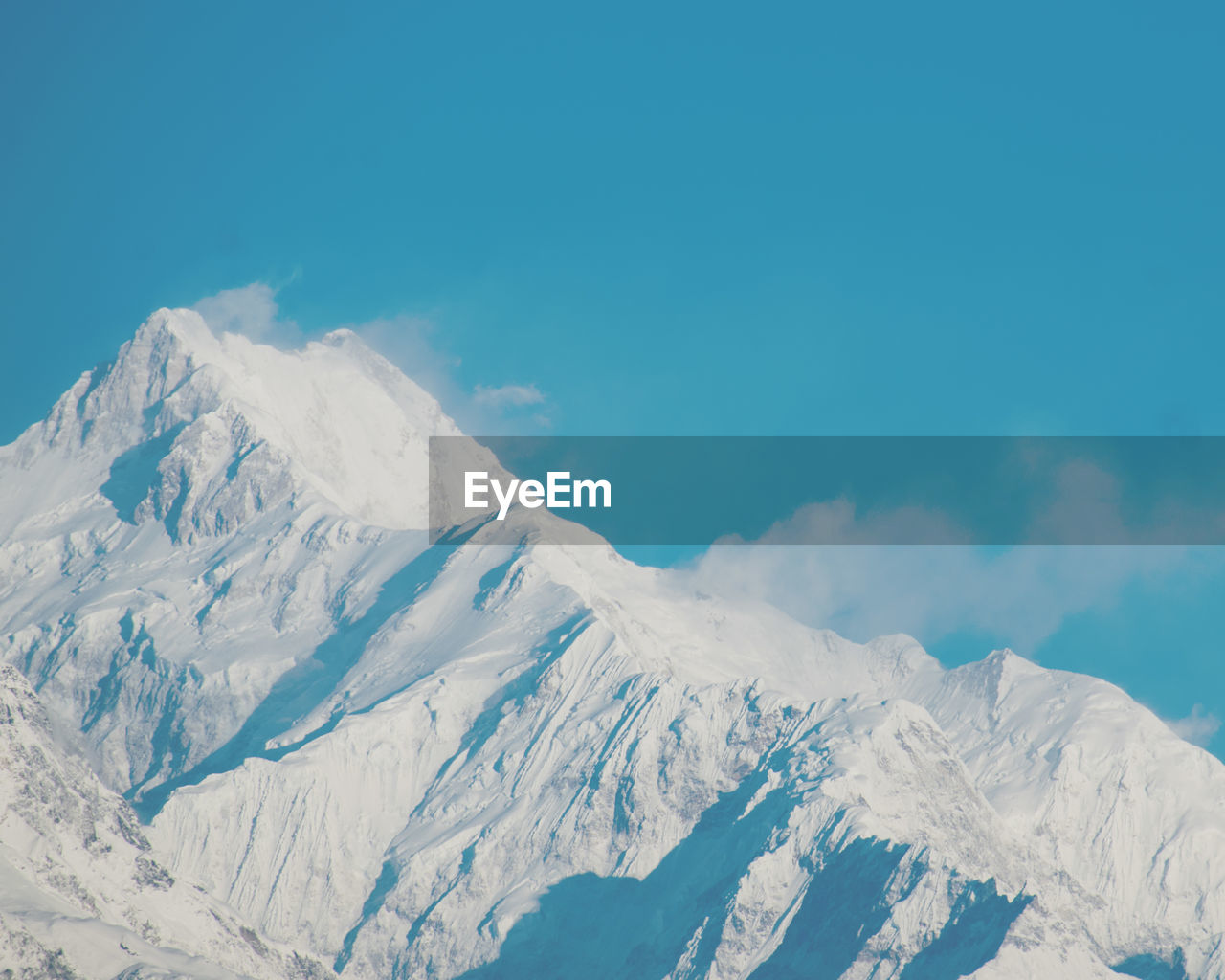 Low angle view of snowcapped mountains against sky