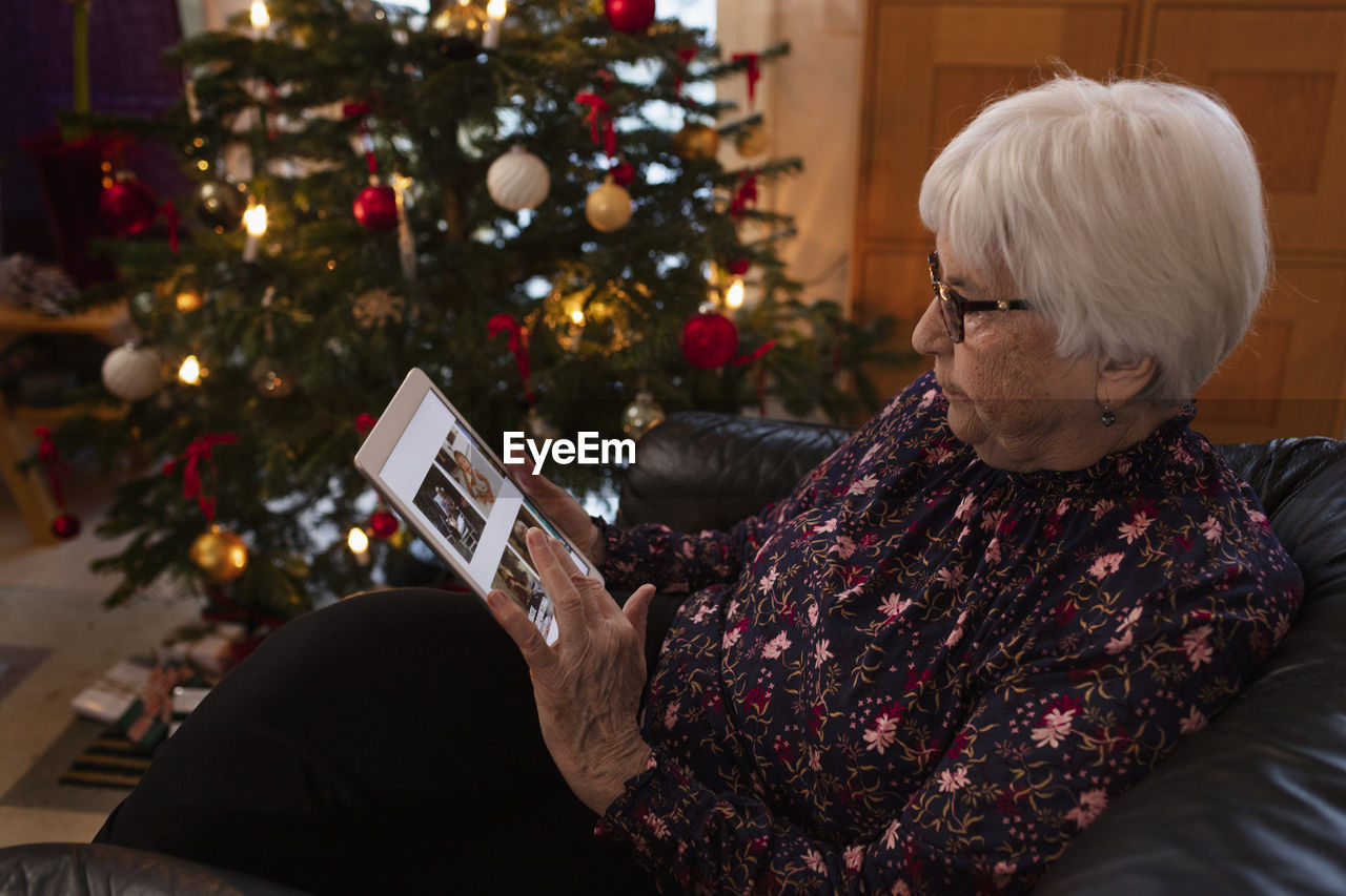 Senior woman using digital tablet at home