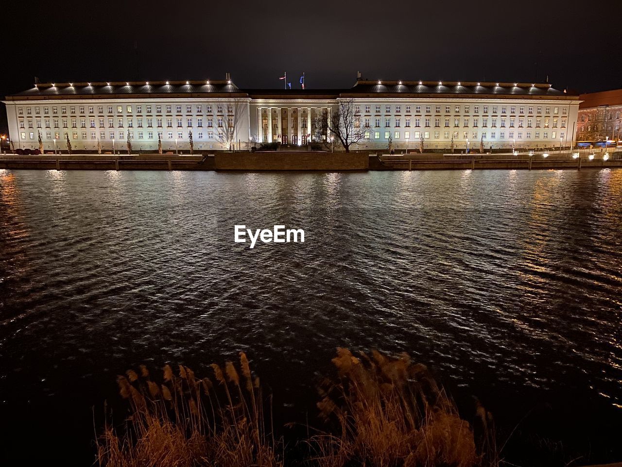 ILLUMINATED BUILDINGS AT WATERFRONT