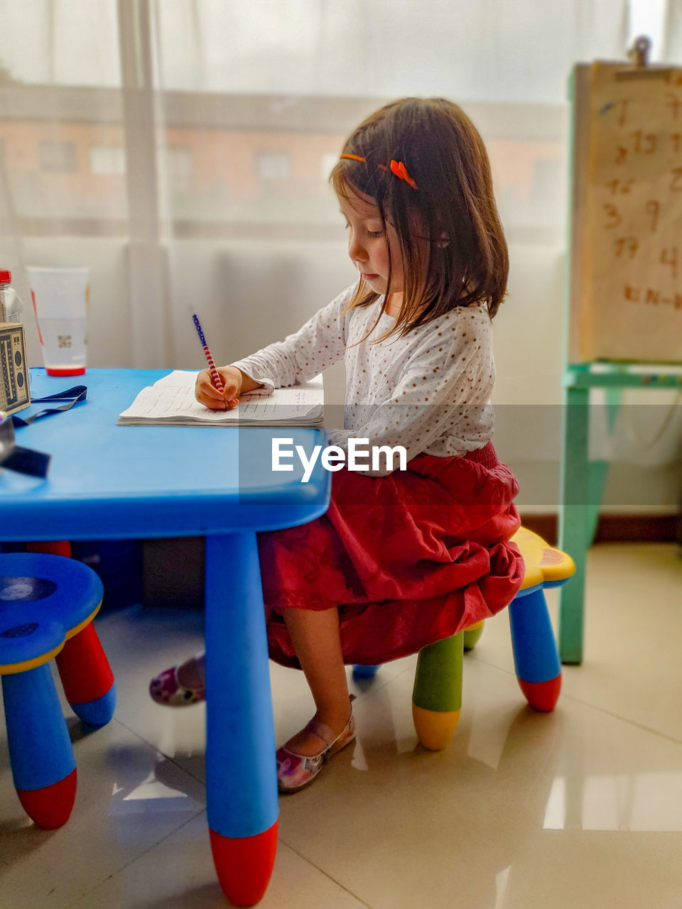 Girl sitting on table at home