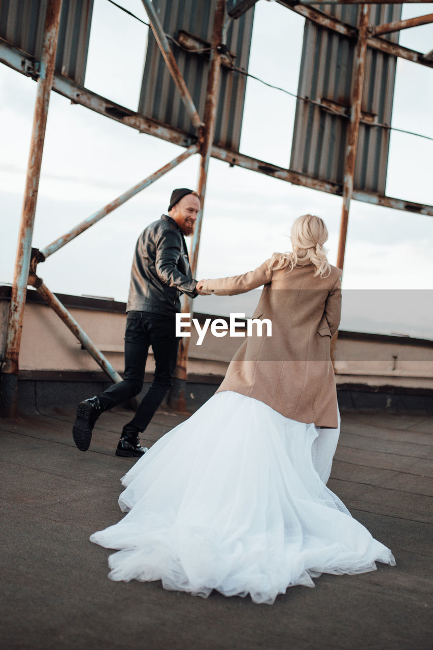 Side view of man and woman standing on hardwood floor