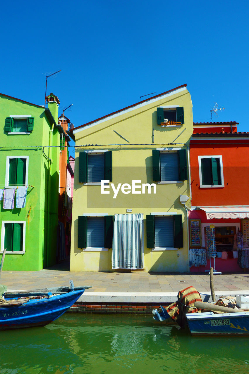 VIEW OF BUILDINGS AGAINST BLUE SKY