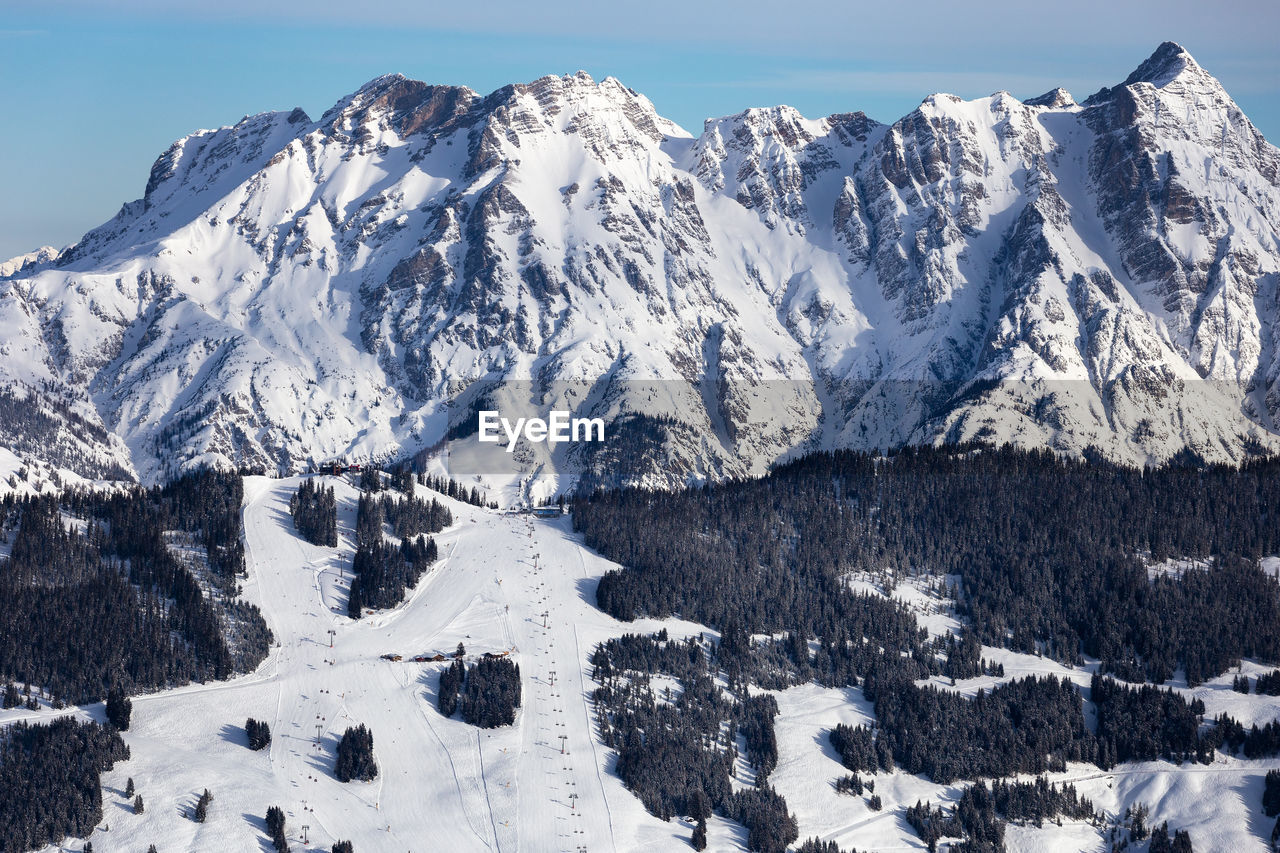 SNOW COVERED MOUNTAIN AGAINST SKY