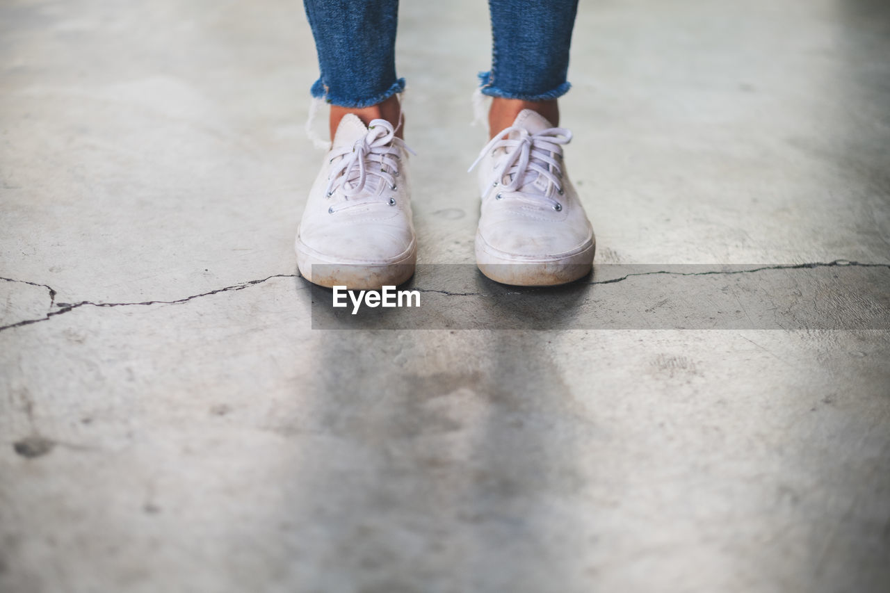 Low section of woman standing on floor