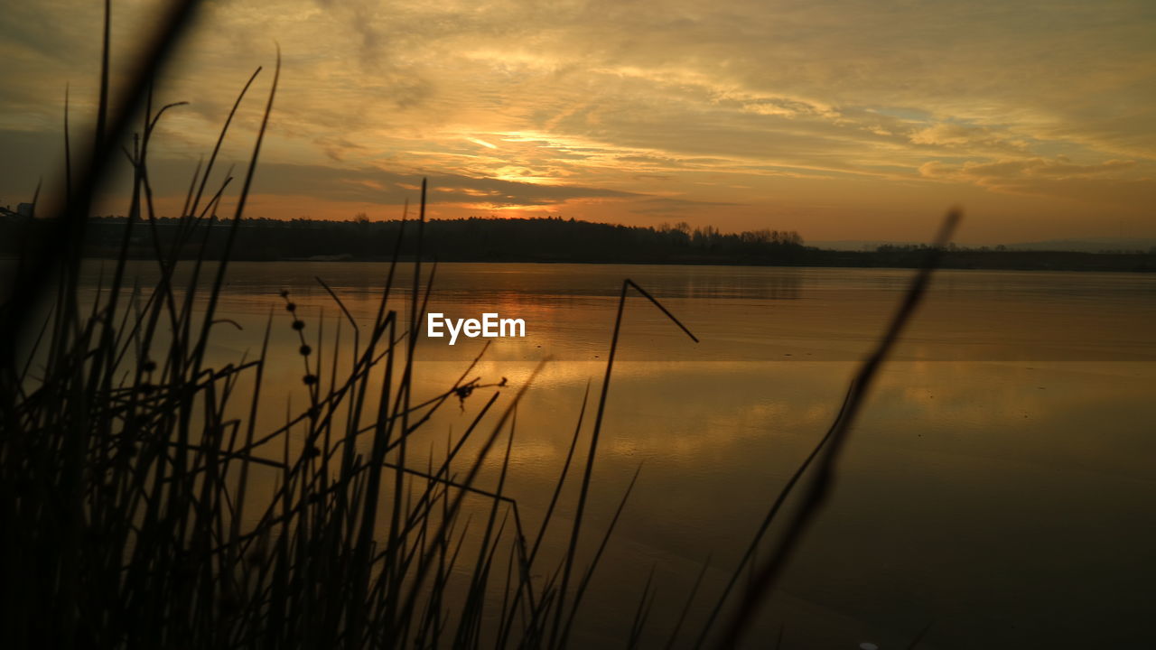 SCENIC VIEW OF LAKE DURING SUNSET