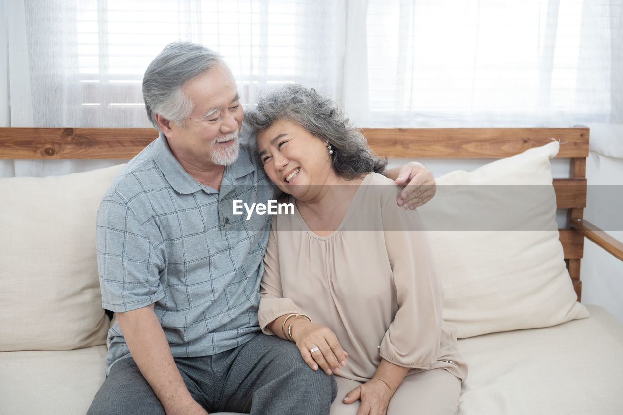 Love.grey-haired man hugging his wife with tenderness at home.