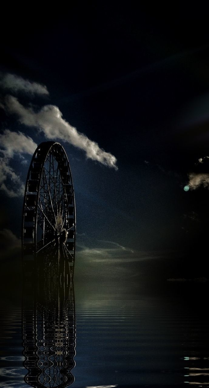 LOW ANGLE VIEW OF FERRIS WHEEL AGAINST THE SKY