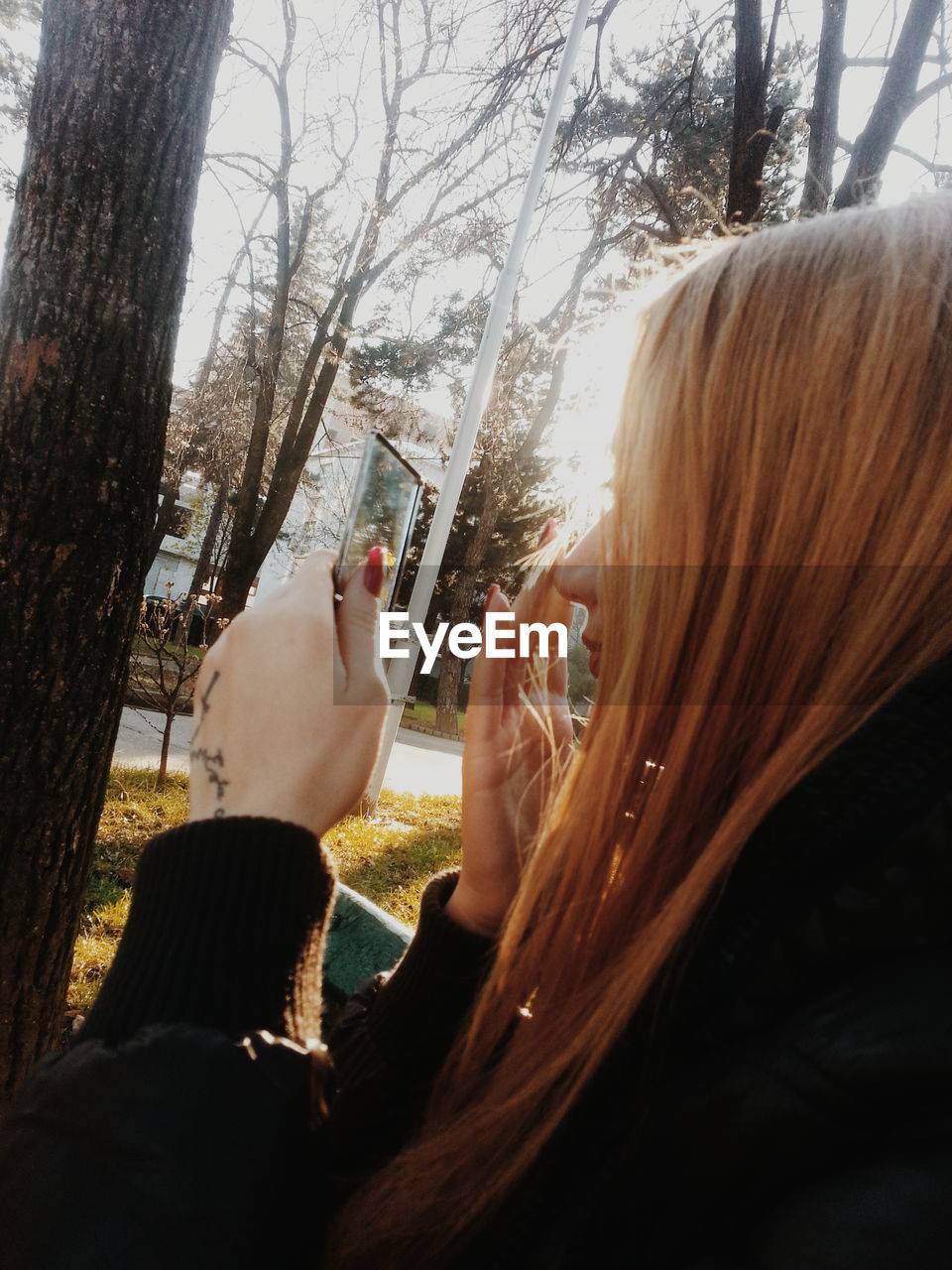 WOMAN WITH HANDS ON TREE