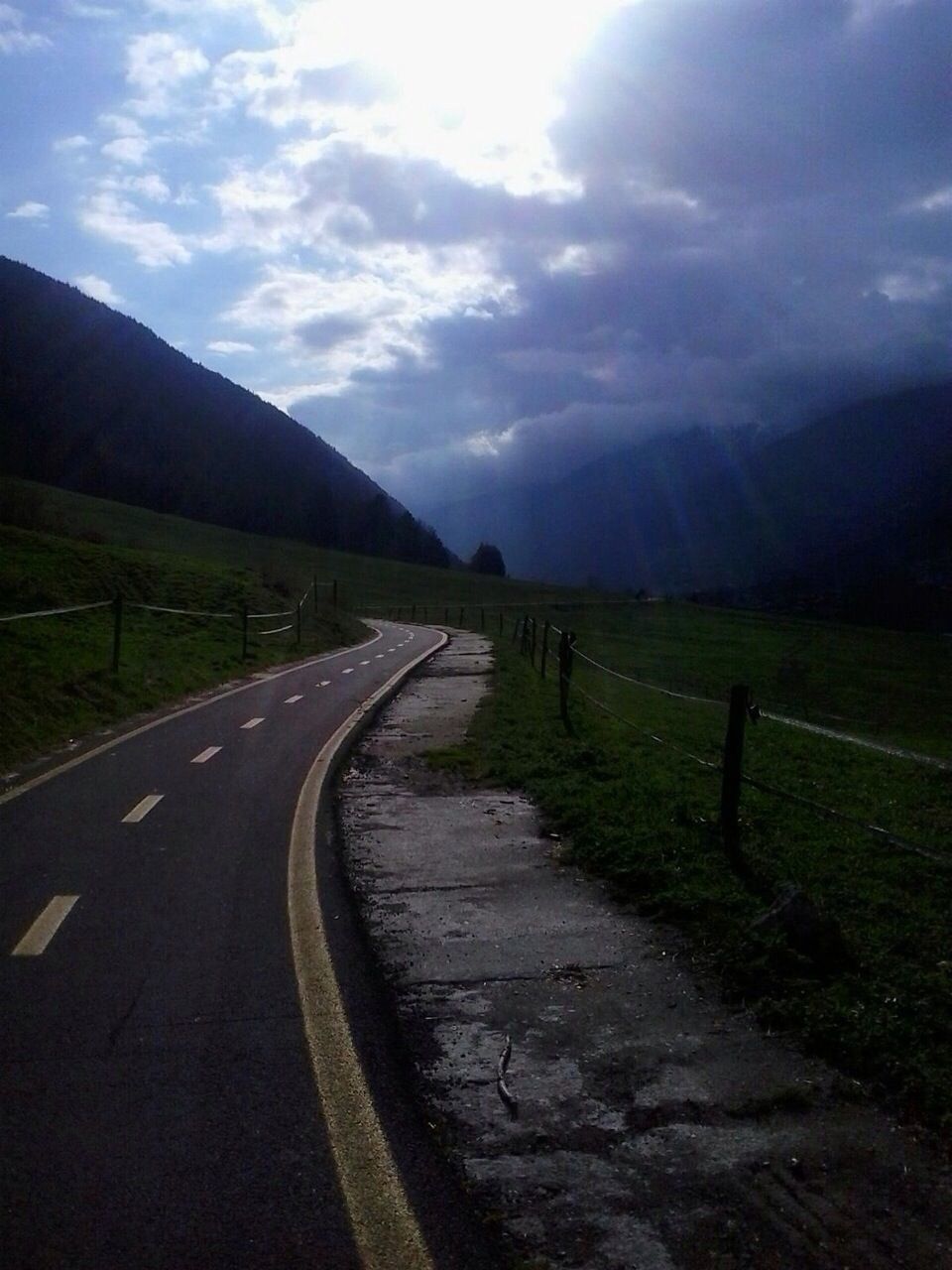 Empty road passing through landscape