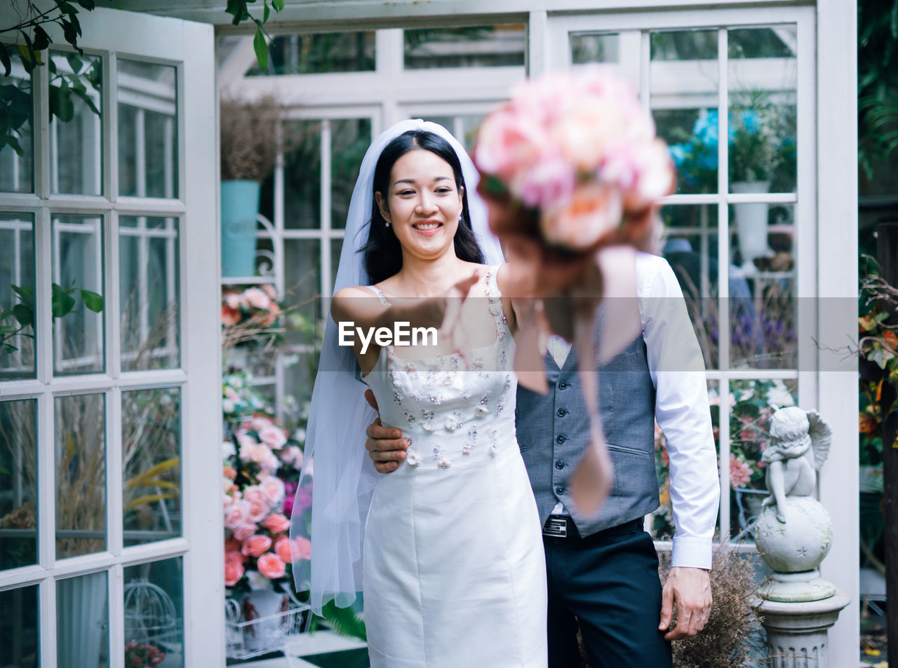 Loving wedding couple standing at backyard