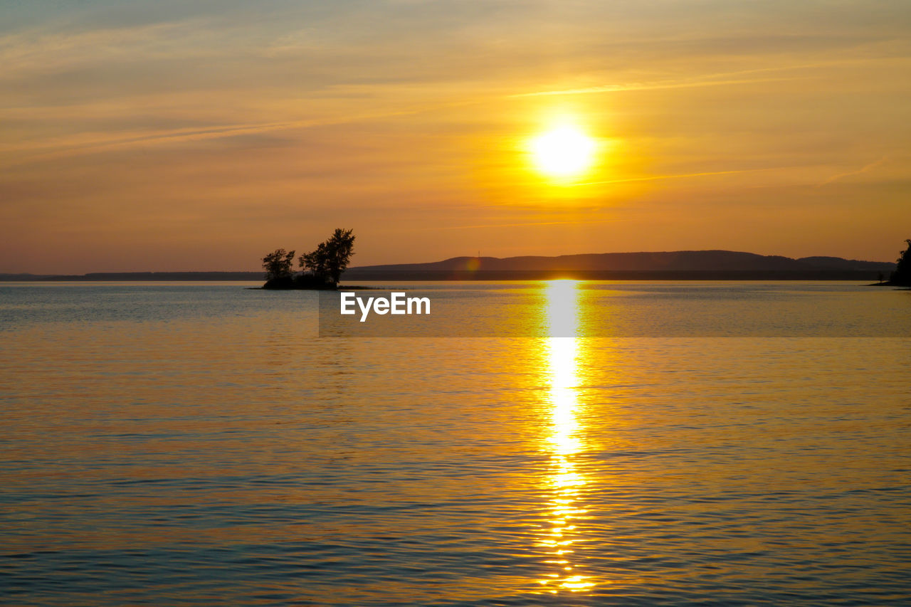 Scenic view of lake against romantic sky at sunset