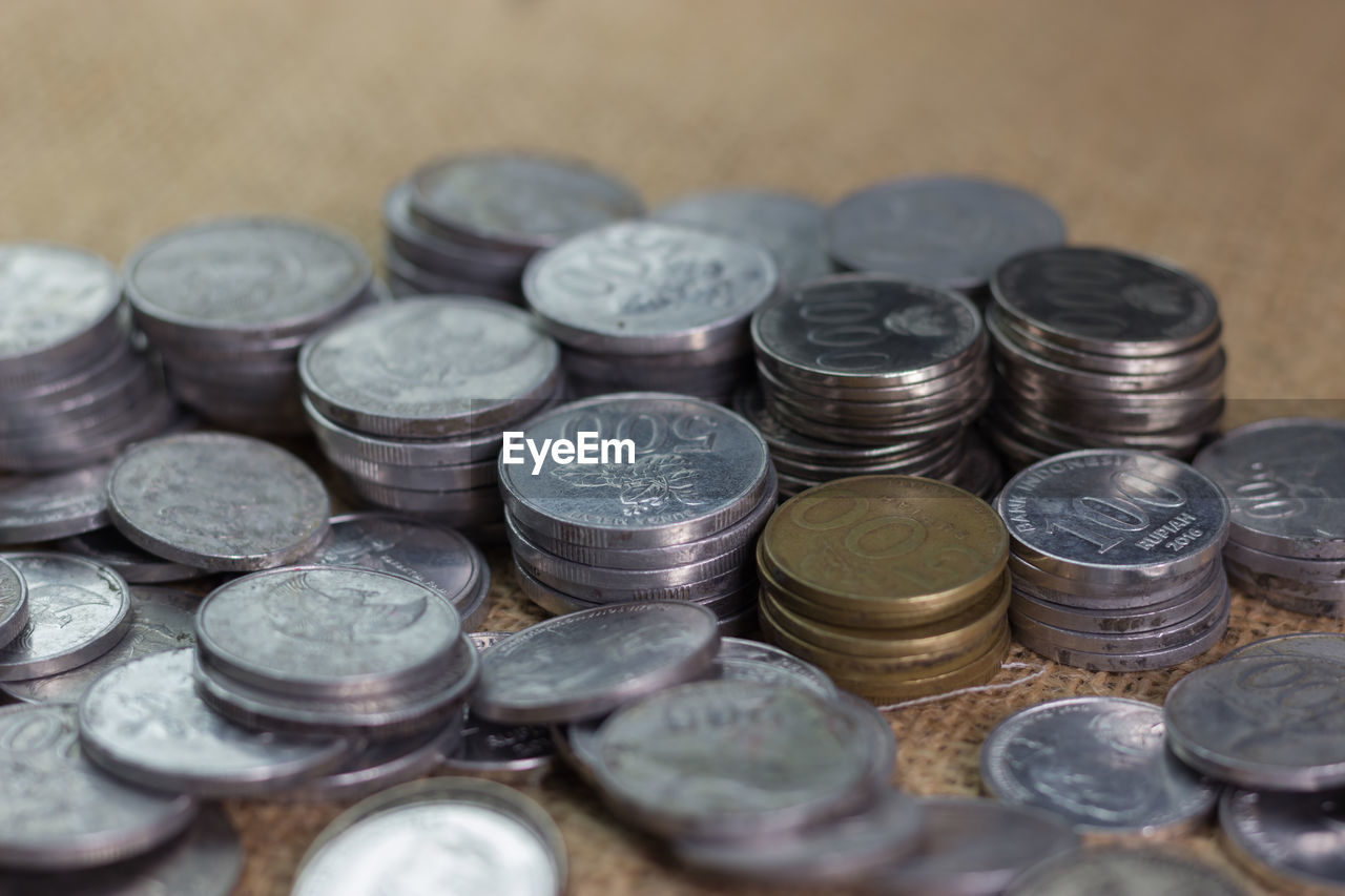 HIGH ANGLE VIEW OF COINS ON METAL