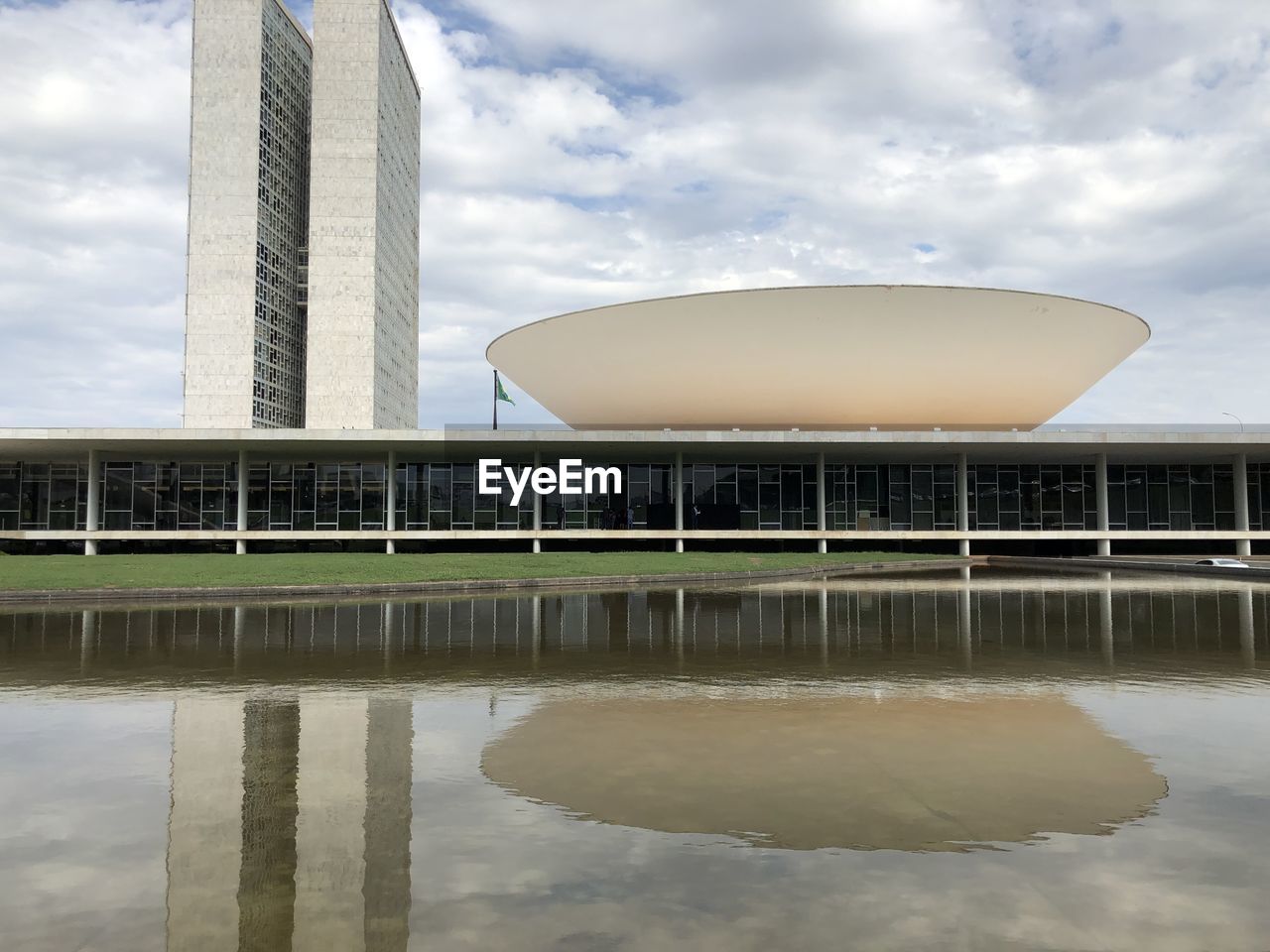 Reflection of building in lake against sky