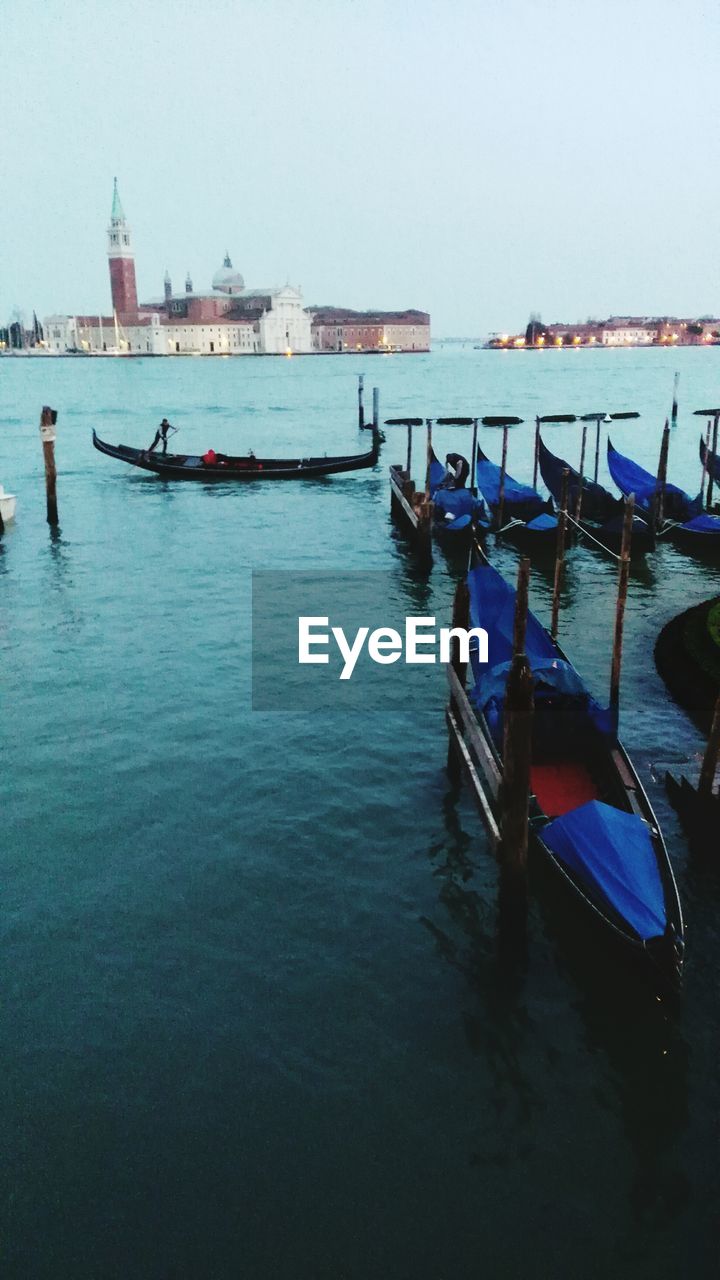 BOATS MOORED IN SEA