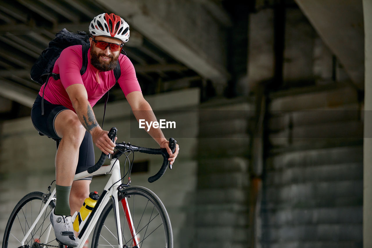 side view of man riding bicycle