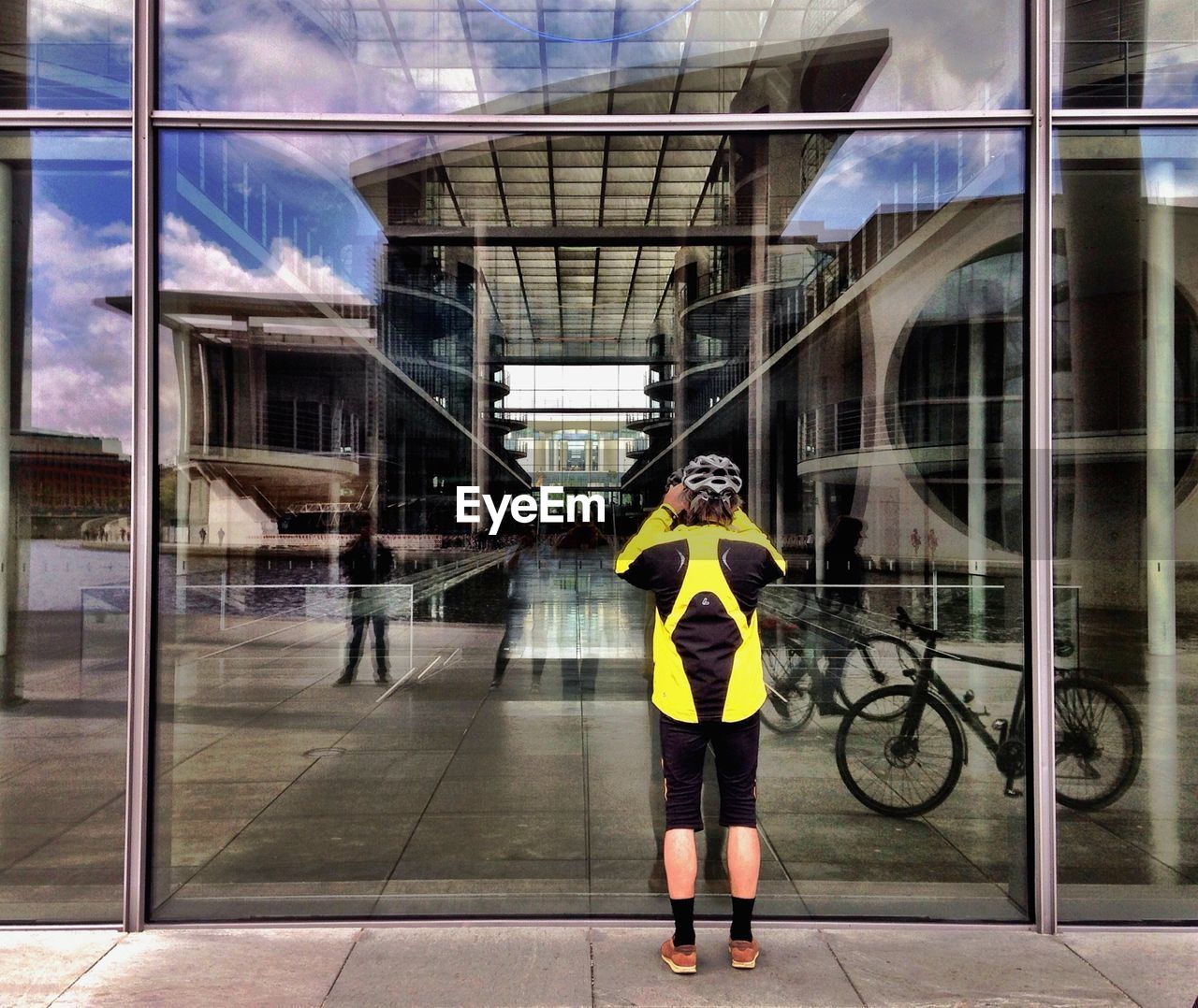 WOMAN STANDING IN FRONT OF BUILDINGS