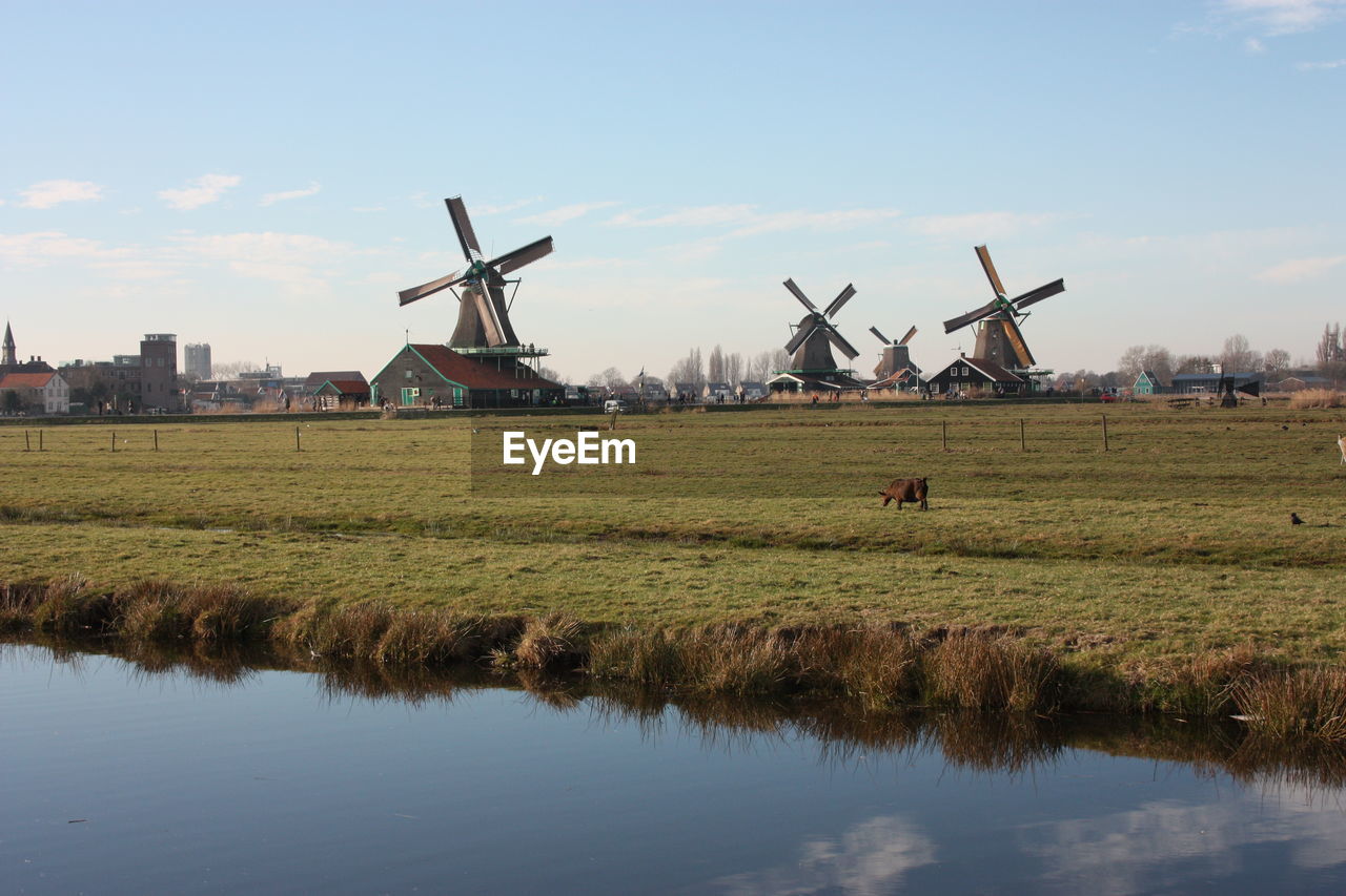 Traditional windmill on field against sky