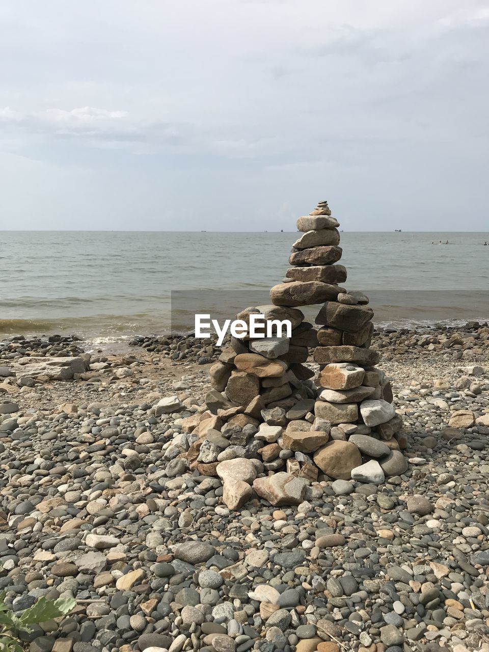 STACK OF PEBBLES ON BEACH