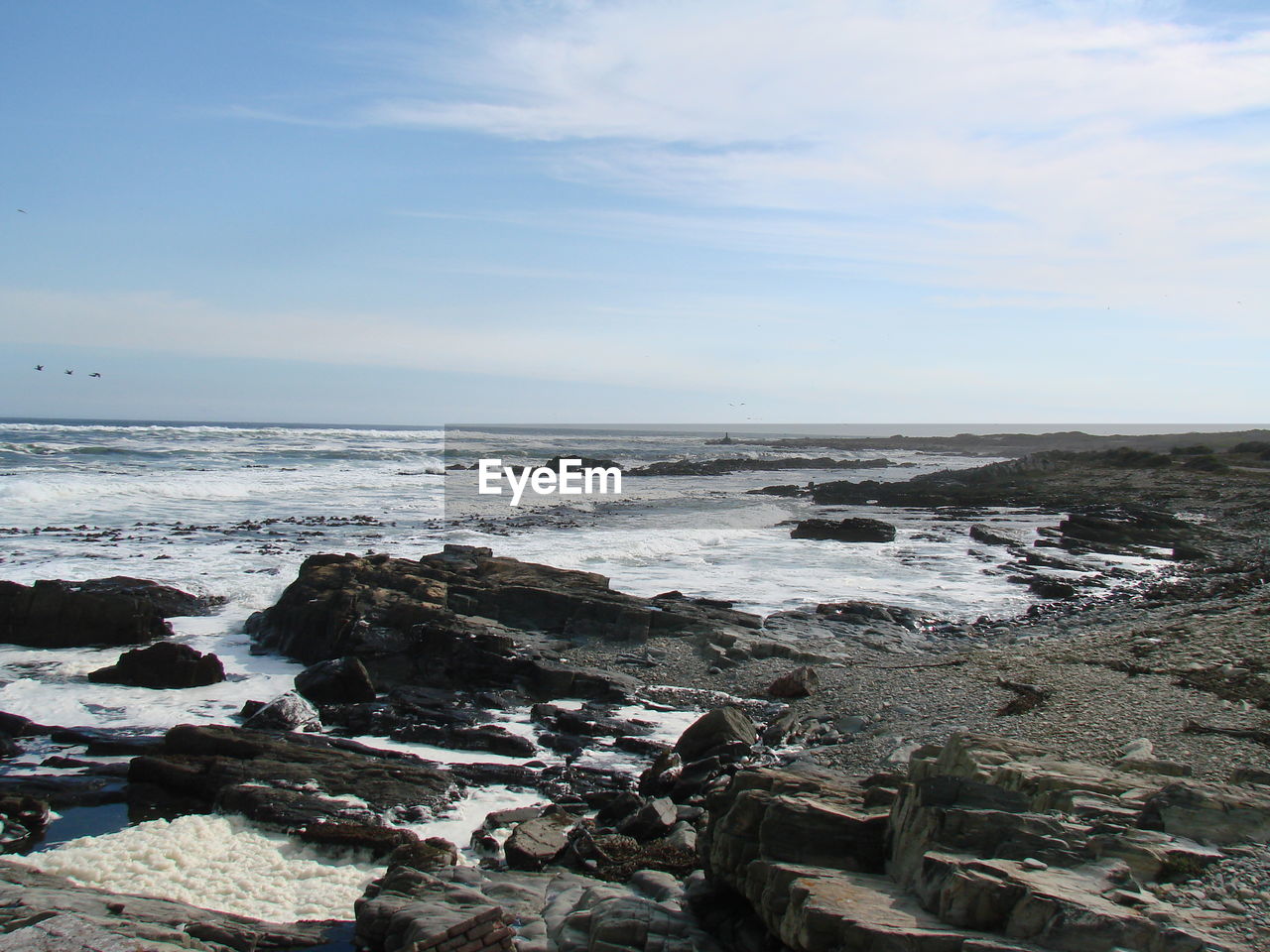 SCENIC VIEW OF SEA AND ROCKS AGAINST SKY