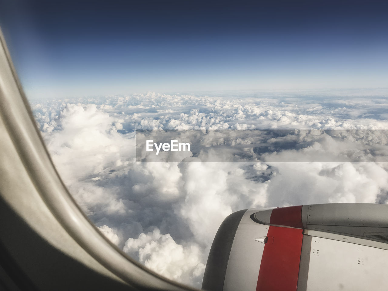 Aerial view of cloudscape seen from airplane window