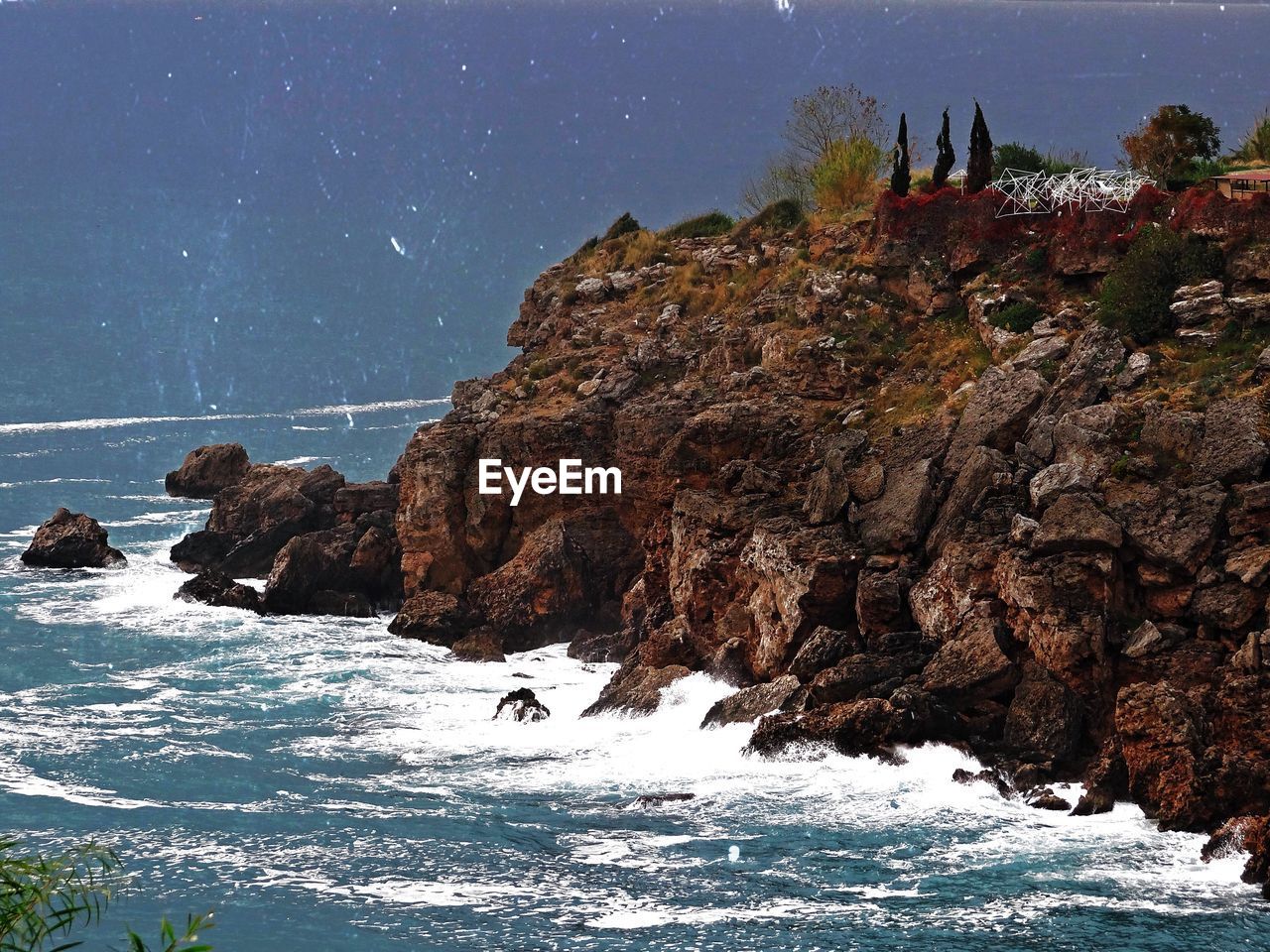 Rock formations in sea against clear sky