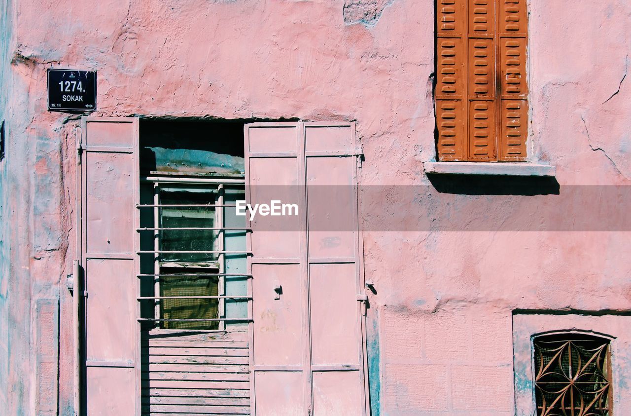 Low angle view of window on building pink