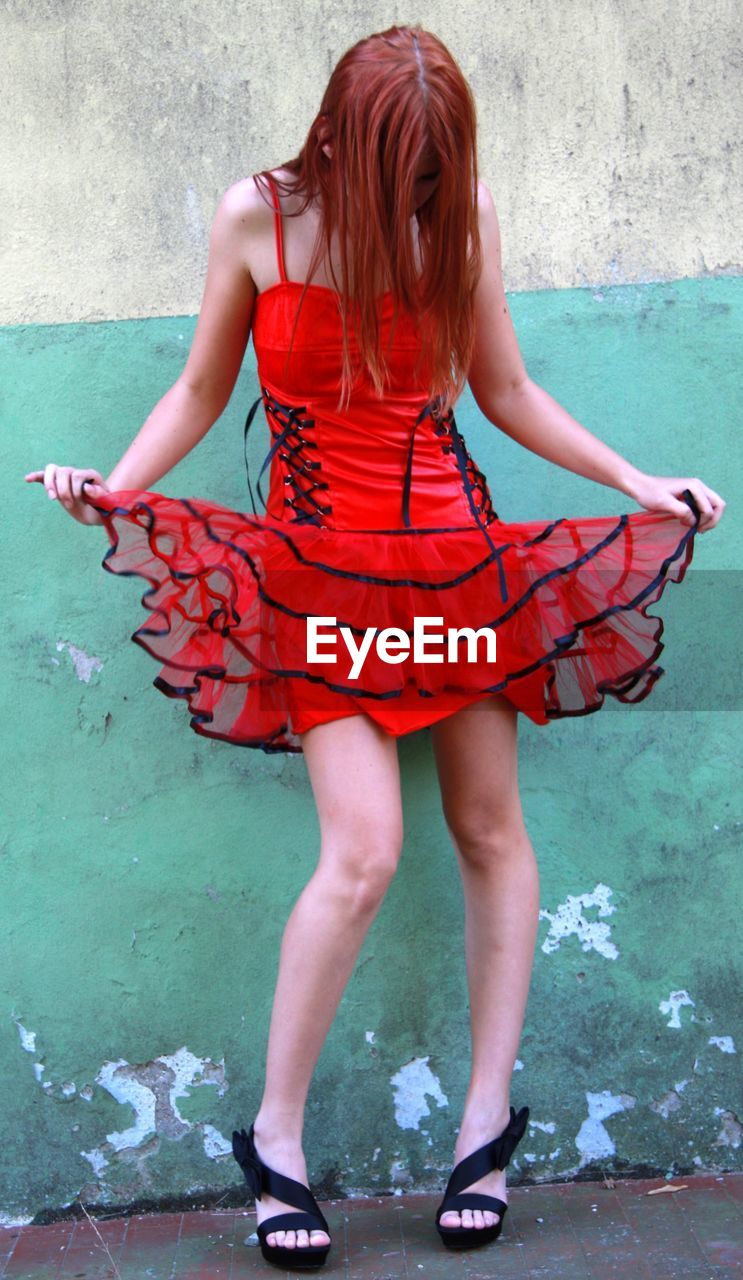 Young girl in red minidress