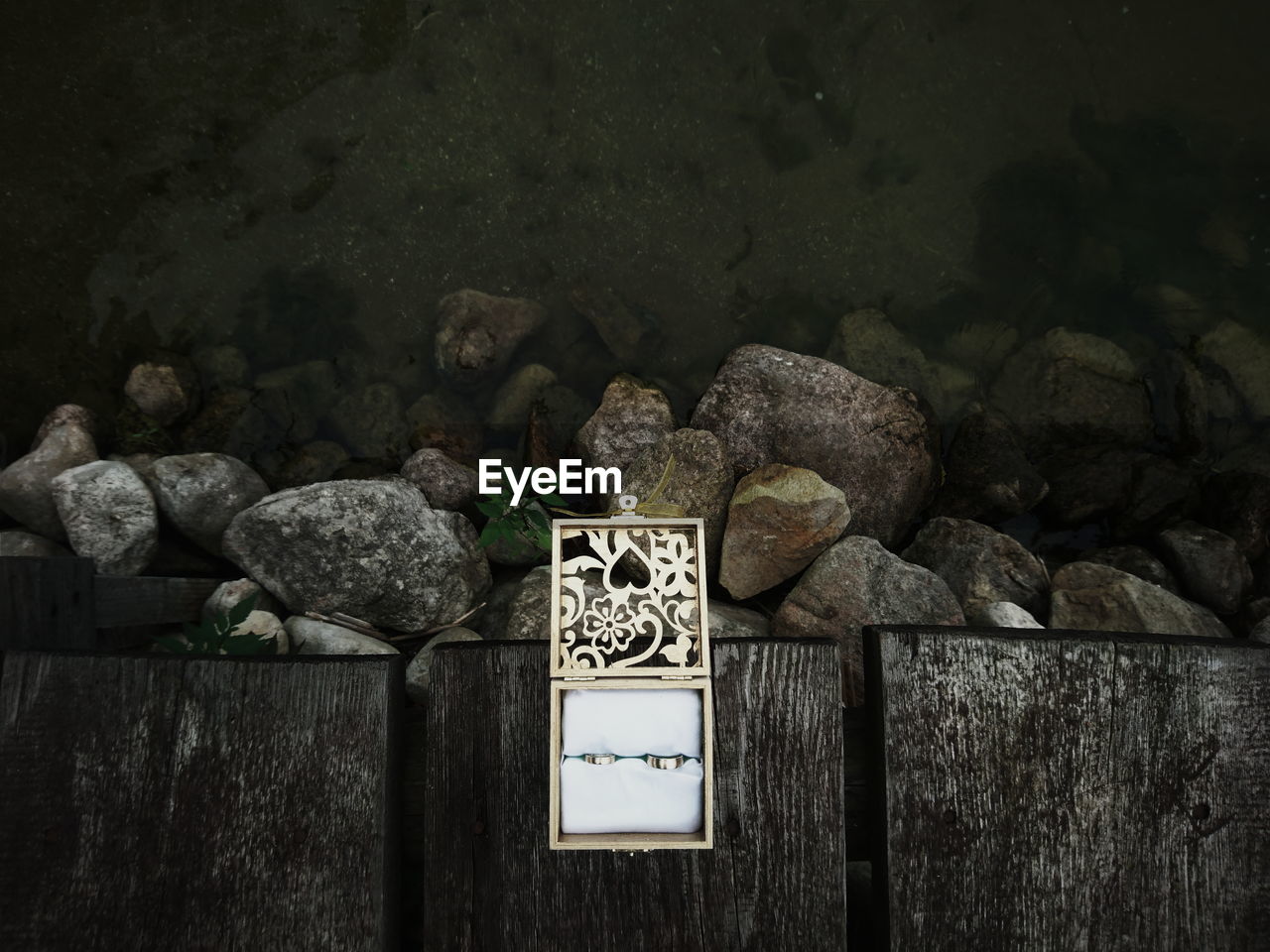 Directly above shot of rings in jewelry box on pier