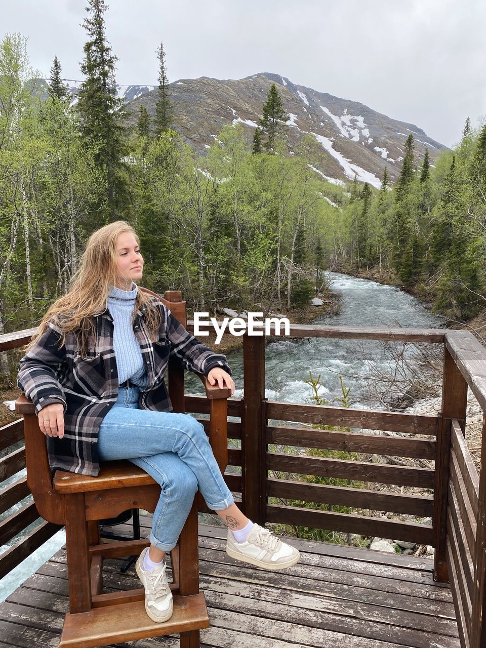 portrait of young woman sitting on bench